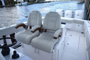 Jupiter 380LS center console helm station with dual Garmin displays, steering wheel, and forward visibility over bow.