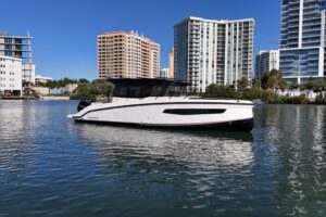 2026 Navan C30 center console boat with bow seating and forward cabin viewed from starboard side in Fort Myers, Florida.