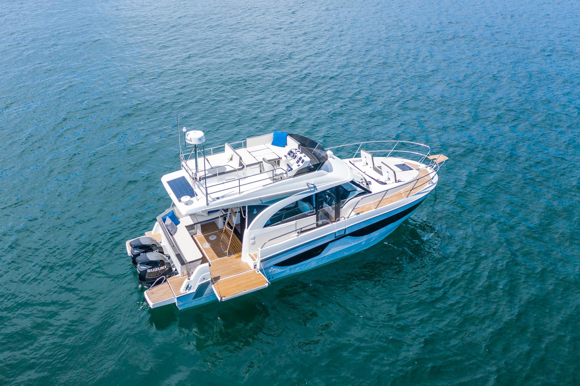 2027 Beneteau Antares 11 Fly 36-foot flybridge yacht profile showing white hull, hardtop, and twin outboard engines.