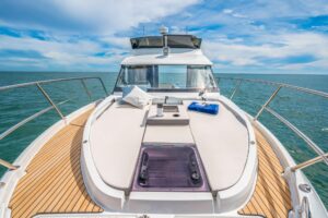2027 Beneteau Antares 11 Fly flybridge helm station with dual helm seats, steering wheel, and forward visibility over the ...