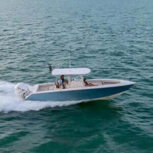 2027 Jupiter 34 center console fishing boat underway on open water, full starboard profile showing hardtop, outriggers, an...