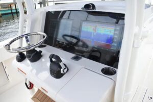 2027 Jupiter 34 center console bow and forward deck showing anchor locker, bow rails, and open layout from elevated angle