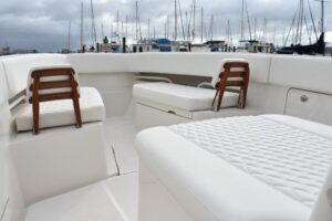 2027 Jupiter 34 center console cockpit and helm station area with seating, electronics displays, and rigging details visib...