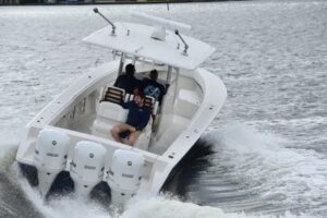 2027 Jupiter 34 center console cockpit helm station with marine electronics displays, steering wheel, and throttle control...