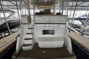 2000 Carver 406 Aft Cabin Motor Yacht helm station with dual helm seats, steering wheel, and instrument panel.