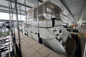 Carver 406 Aft Cabin Motor Yacht helm station with dual helm seats, steering wheel, and instrument panel.