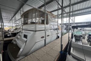 2000 Carver 406 Aft Cabin Motor Yacht helm station with dual helm seats, steering wheel, and instrument panel.