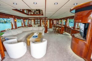 94-foot Destiny flybridge motor yacht showing bow profile and forward deck with teak railings and anchor windlass in Miami.