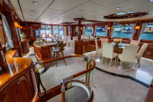 Destiny 94-foot flybridge motor yacht helm station with dual helm chairs, Garmin navigation displays, and overhead hardtop...