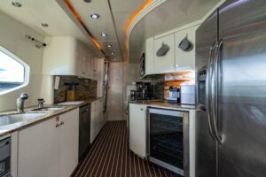 94-foot Destiny flybridge motor yacht helm station with dual helm chairs, Garmin electronics displays, and overhead hardto...