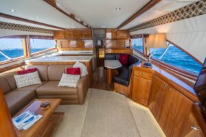 Helm station of 2001 Bertram 510 Convertible with dual helm seats, Garmin electronics displays, steering wheel, and overhe...