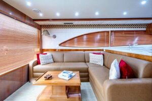 Helm station with dual Garmin displays, leather helm chair, and stainless steel wheel aboard 2001 Bertram 510 Convertible.