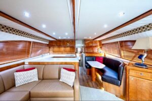 Bertram 510 Convertible helm station with dual Garmin displays, leather helm chair, and forward visibility through windshi...