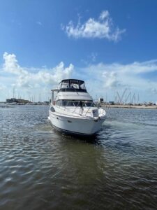 Helm station with dual Garmin displays and center console steering aboard 2001 Carver 444 Cockpit Motor Yacht.