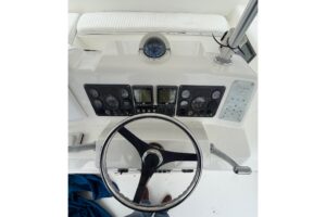 2001 Egg Harbor 42 Convertible helm station with dual Garmin displays, steering wheel, and engine throttle controls.