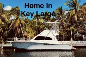2001 Luhrs 40 Convertible sport fishing yacht with white hull and hardtop cruising profile in Key Largo waters.