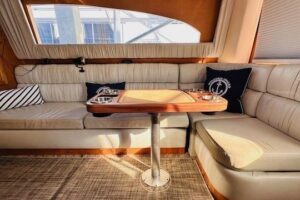2001 Luhrs 40 Convertible helm station with dual Garmin displays, leather seating, and hardtop overhead.