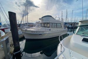 2002 Camano 30 cruiser with white hull and hardtop viewed from starboard side in Anacortes, Washington.