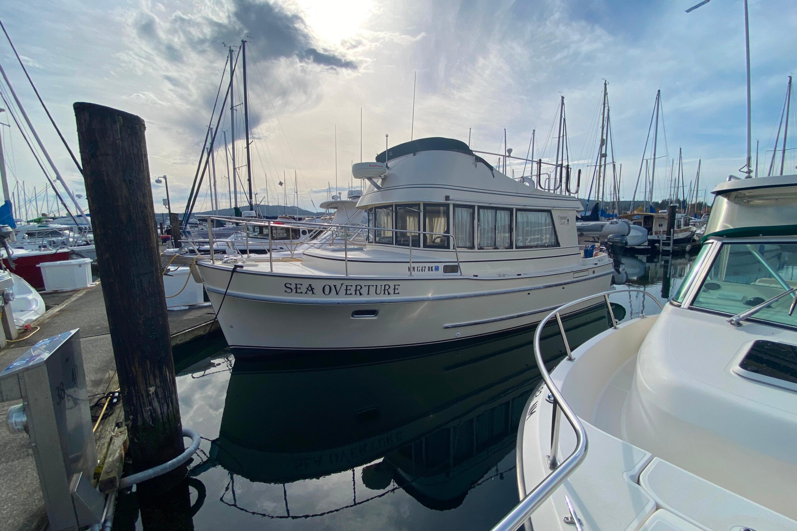 2002 Camano 30 cruiser with white hull and hardtop viewed from starboard side in Anacortes, Washington.