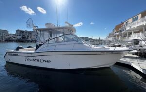 2002 Grady-White Express 330 center console fishing boat with twin outboard engines moored at Sea Isle, New Jersey.