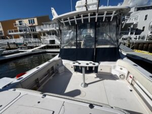 Grady-White Express 330 center console helm station with dual Garmin displays, steering wheel, and throttle controls.