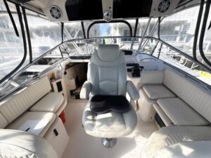 Grady-White Express 330 helm station with dual Garmin displays, center console steering, and forward visibility through wi...