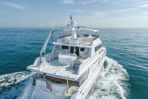 Bow view of 2002 President 100 motor yacht with teak railings and forward seating in Fort Lauderdale.