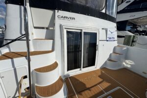 Carver 444 Cockpit Motor Yacht helm station with dual helm chairs, steering wheel, and instrument panel.