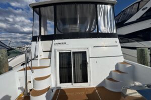 Carver 444 Cockpit Motor Yacht helm station with dual helm seats, steering wheel, and instrument panel.