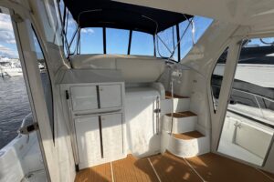 Carver 444 Cockpit Motor Yacht helm station with dual helm seats, steering wheel, and instrument panel displays.