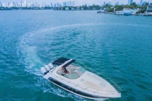 Helm station of 2003 Formula 34 Performance Cruiser with dual helm seats, center console steering, and forward windshield ...