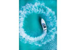 2003 Formula 34 Performance Cruiser helm station with dual Garmin displays, center console steering, and forward visibilit...