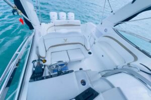 Helm station of 2003 Formula 34 Performance Cruiser with dual helm seats, center console steering, and forward visibility ...