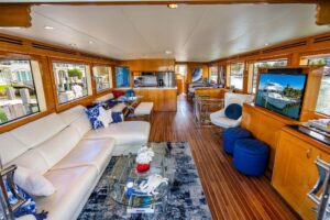 2003 Hatteras 75 Cockpit Motor Yacht stern quarter view showing teak transom, swim platform, and dual exhaust ports in Hil...