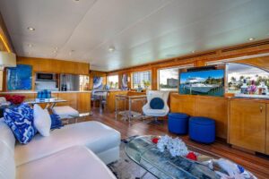 2003 Hatteras 75 Cockpit Motor Yacht with teak cockpit seating, helm station, and hardtop in Hillsboro Beach, Florida.