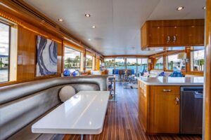 2003 Hatteras 75 Cockpit Motor Yacht helm station with Garmin electronics and dual helm chairs in the pilothouse.
