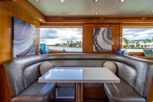 2003 Hatteras 75 Cockpit Motor Yacht with teak cockpit seating, helm station, and hardtop canopy in Hillsboro Beach, Florida.
