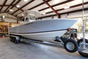 2003 Regulator 32 center console fishing boat with twin outboard engines and hardtop, photographed from starboard side in ...