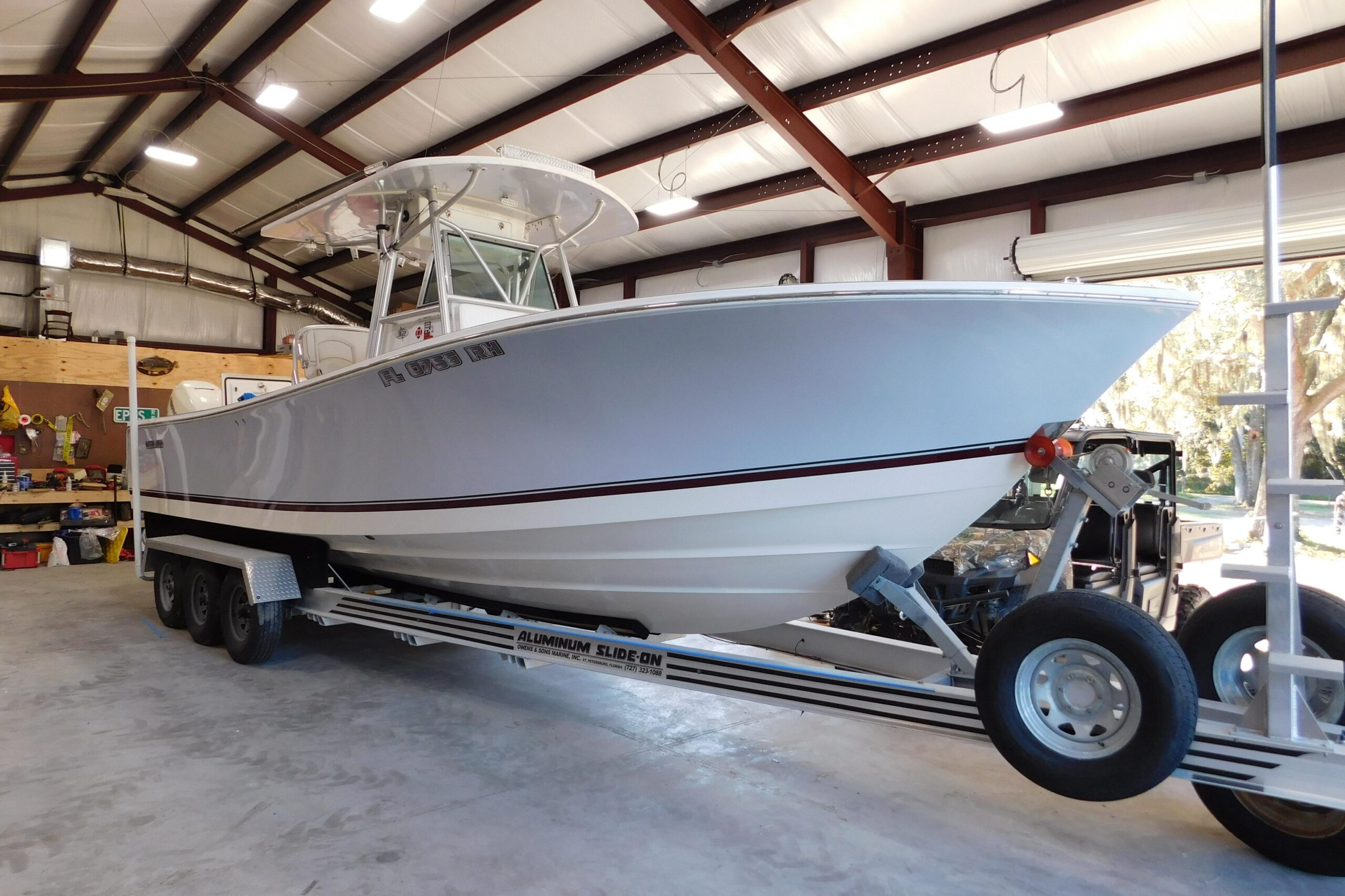 2003 Regulator 32 center console fishing boat with twin outboard engines and hardtop, photographed from starboard side in ...