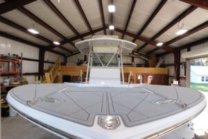 2003 Regulator 32 center console helm station with dual Garmin displays, steering wheel, and throttle controls.