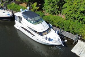 Carver 466 Motor Yacht salon with upholstered seating, entertainment center, and cabin lighting.