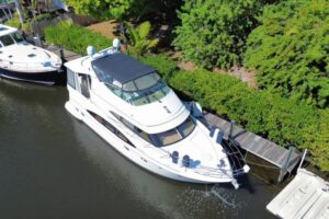 Galley with stainless steel appliances and wood cabinetry aboard 2004 Carver 466 Motor Yacht.