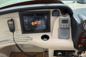 Carver 466 Motor Yacht salon with upholstered seating, entertainment center, and cabin access in Cleveland, OH.