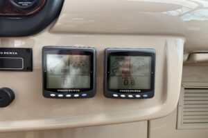 Carver 466 Motor Yacht helm station with dual Garmin displays, leather captain's chair, and forward cabin visibility throu...