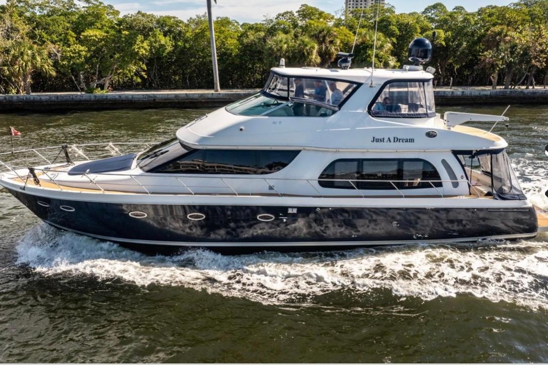 2005 Carver 56 Voyager motor yacht exterior profile showing full-length starboard side with twin smokestacks and cruising ...