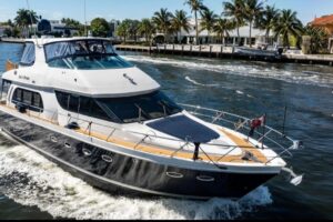 Stern view of 2005 Carver 56 Voyager motoryacht showing transom, swim platform, and aft deck configuration in Fort Lauderd...