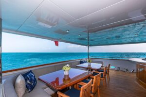 2005 Christensen 157-foot motor yacht with classic teak and white exterior profile, anchored in San Diego waters.