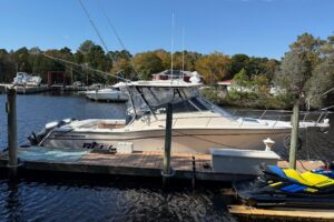 2005 Grady-White Express 330 center console fishing yacht with twin outboard engines moored in profile view.
