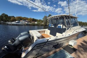 2005 Grady-White Express 330 bow seating area with forward cabin entry and windshield.