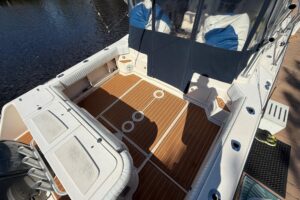 Grady-White Express 330 helm station with dual Garmin displays, center console steering, and forward visibility through wi...